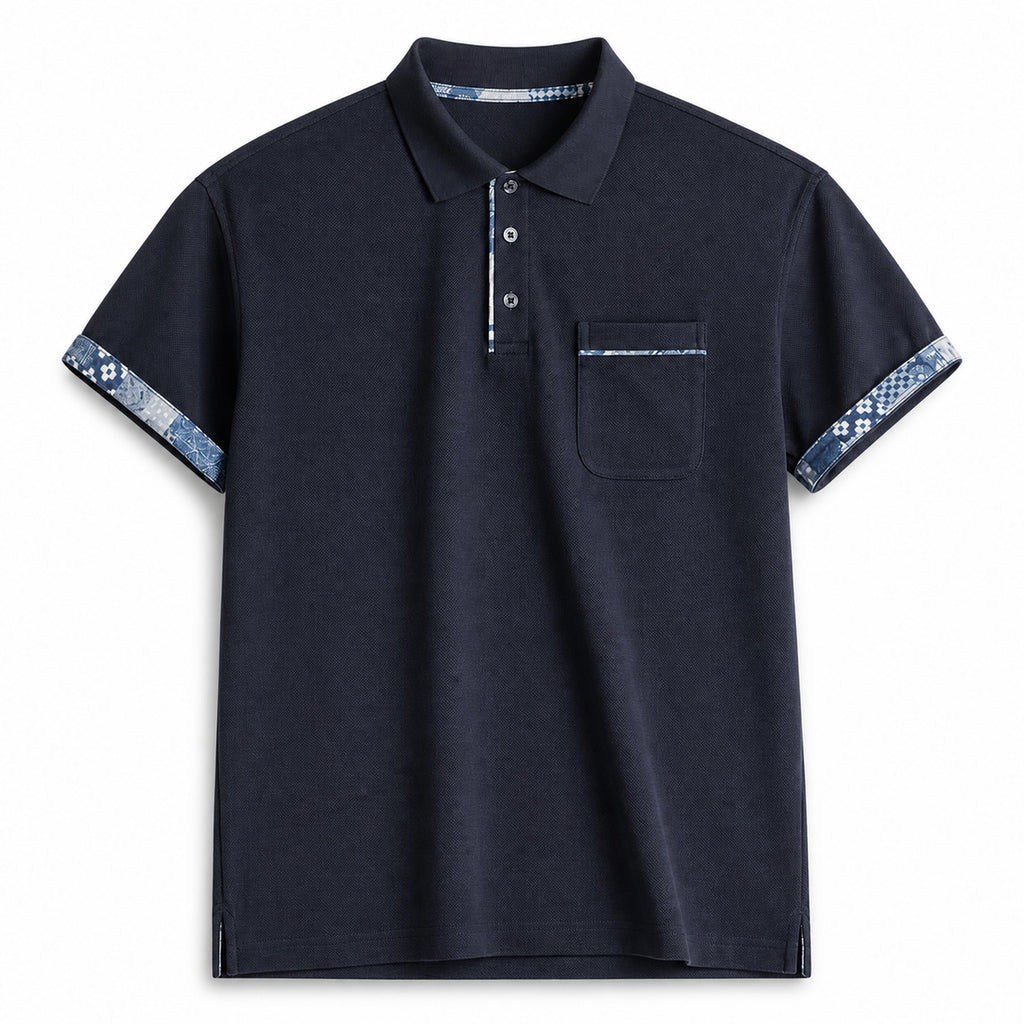 Navy pocket polo with indigo pattern trim at cuffs, flat front view