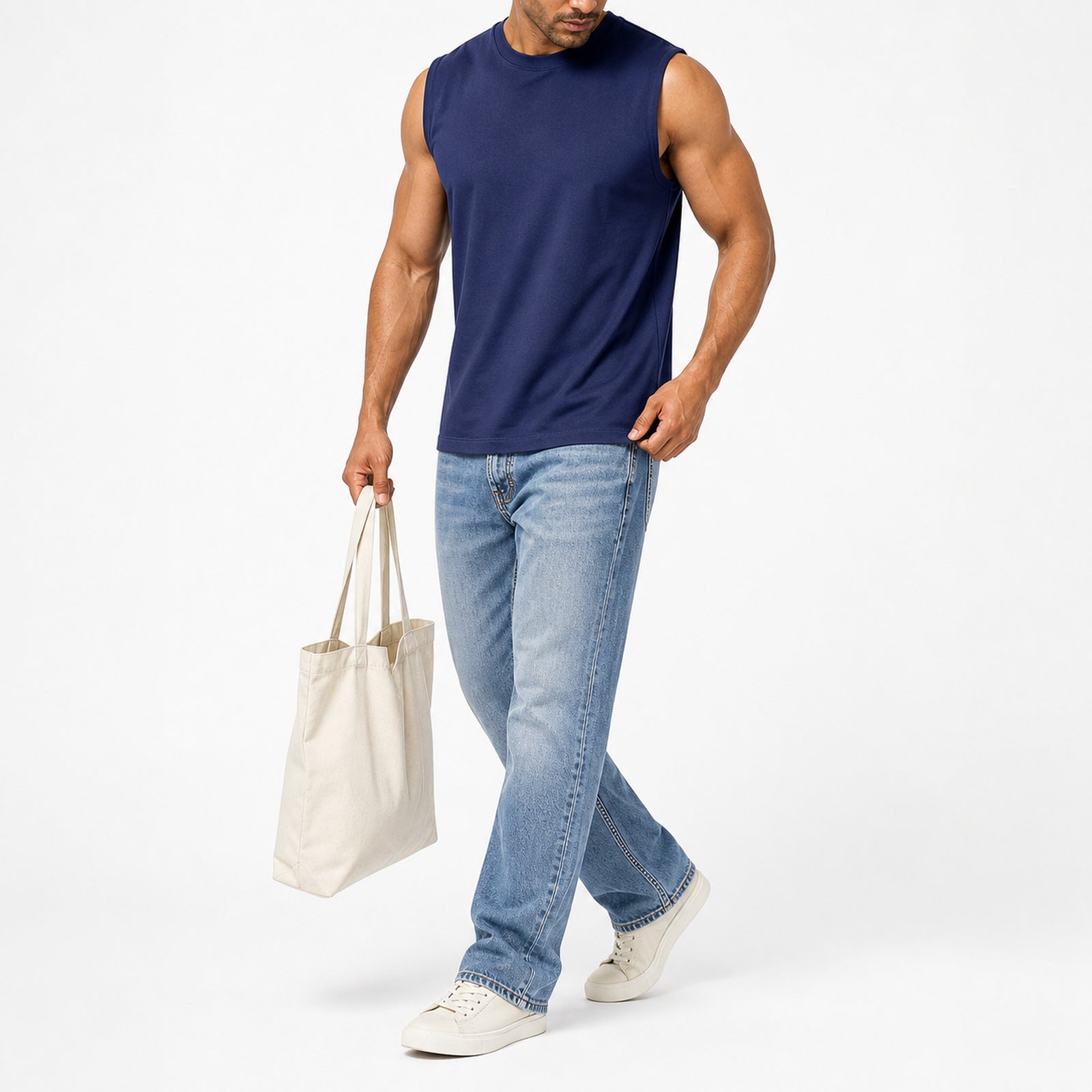 Man wearing the navy blue muscle tank with light jeans, full view