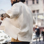 Back view of a man wearing the white lyocell camp shirt outdoors
