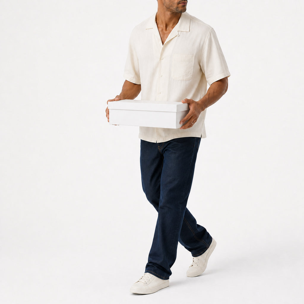 Man wearing the white lyocell camp shirt with navy trousers, full view