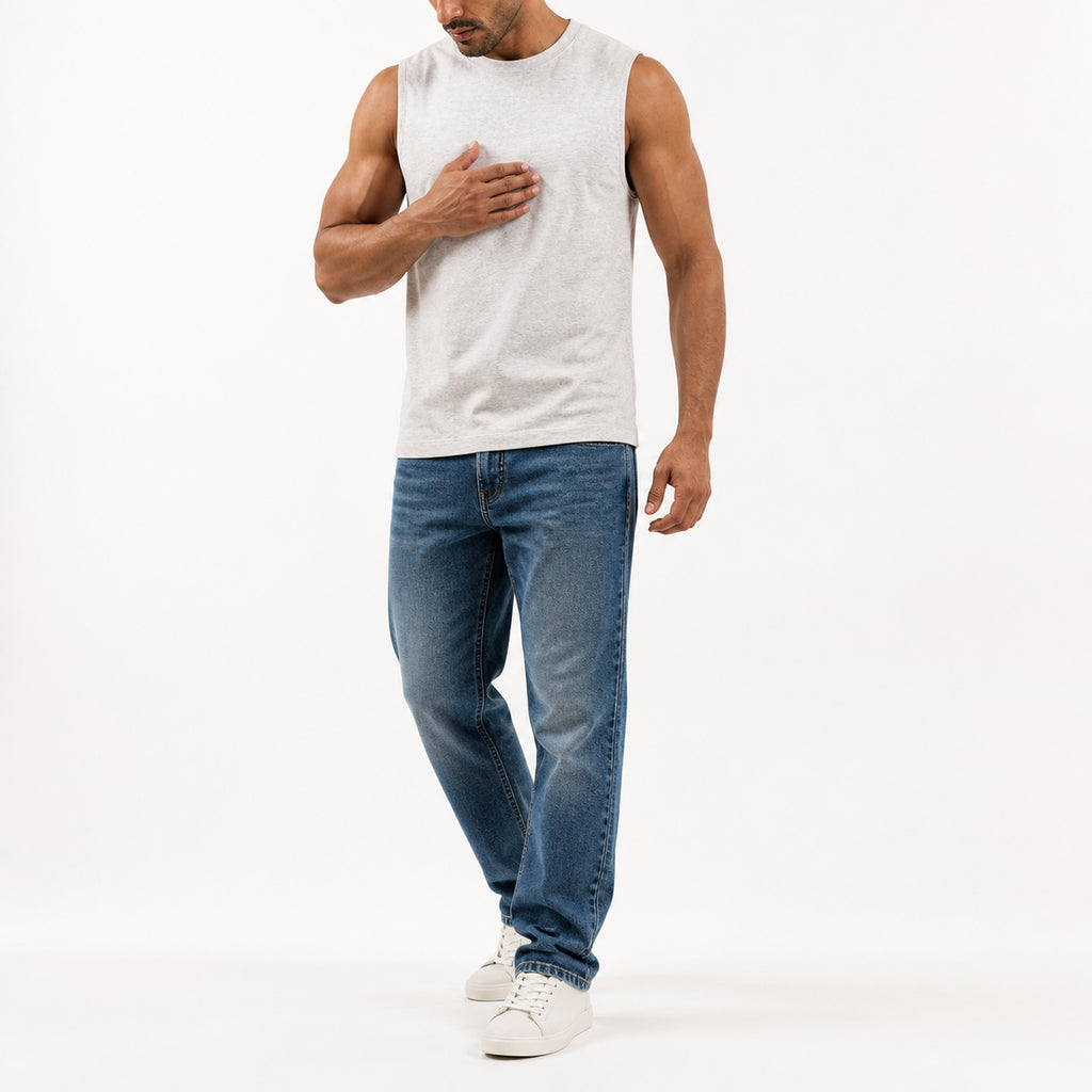 Man wearing the off-white muscle tank with blue jeans, full view