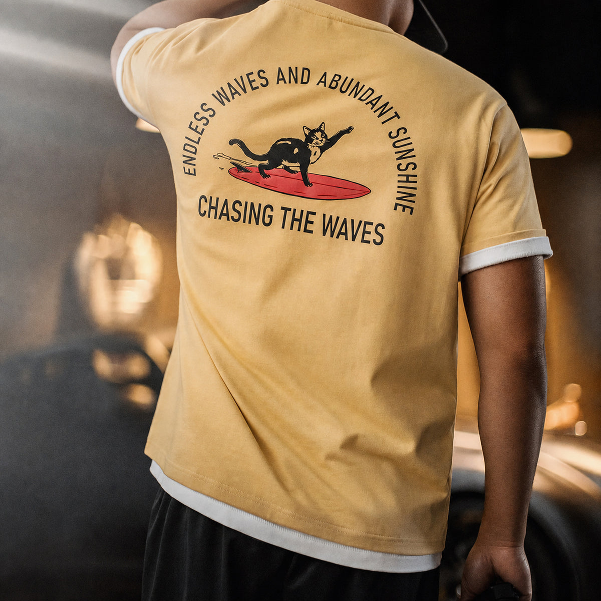 Back view of the mustard surf cat tee showing the surfing cat print