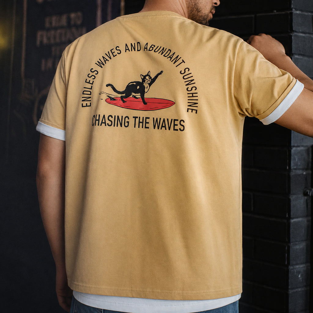 Man wearing the mustard surf cat tee, back print visible