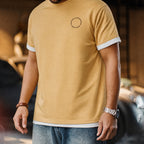 Front view of the mustard tee with small circular chest mark
