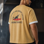 Man in the mustard surf cat tee styled over a white base tee